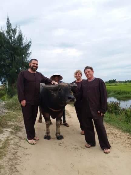 Farmer guiding a couple through the rice paddies