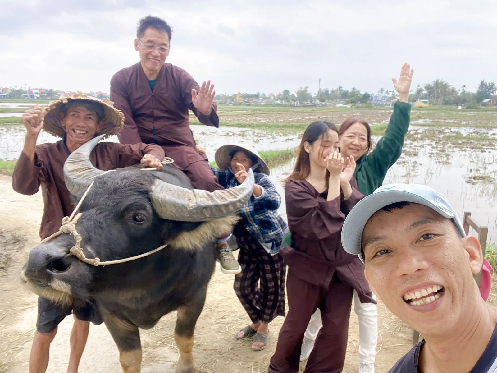 Best Hoi An tour: Ao Dai riders guiding a water buffalo riding and countryside discovery experience