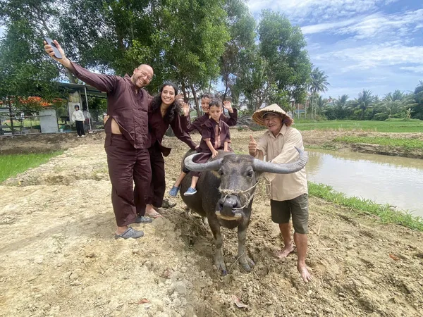 Best Hoi An tour: Ao Dai riders guiding a water buffalo riding and countryside discovery experience